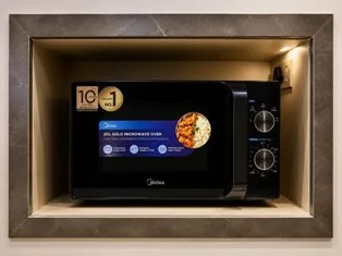 Microwave oven in the shared kitchen at Zest Stays 1059 PG