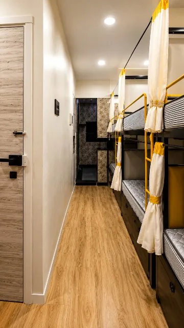 Bunk beds with individual privacy curtains and storage drawers at Zest Stays 1059