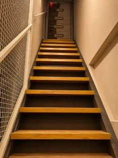 Well-lit wooden staircase entry at Zest Stays 1059 Santacruz East